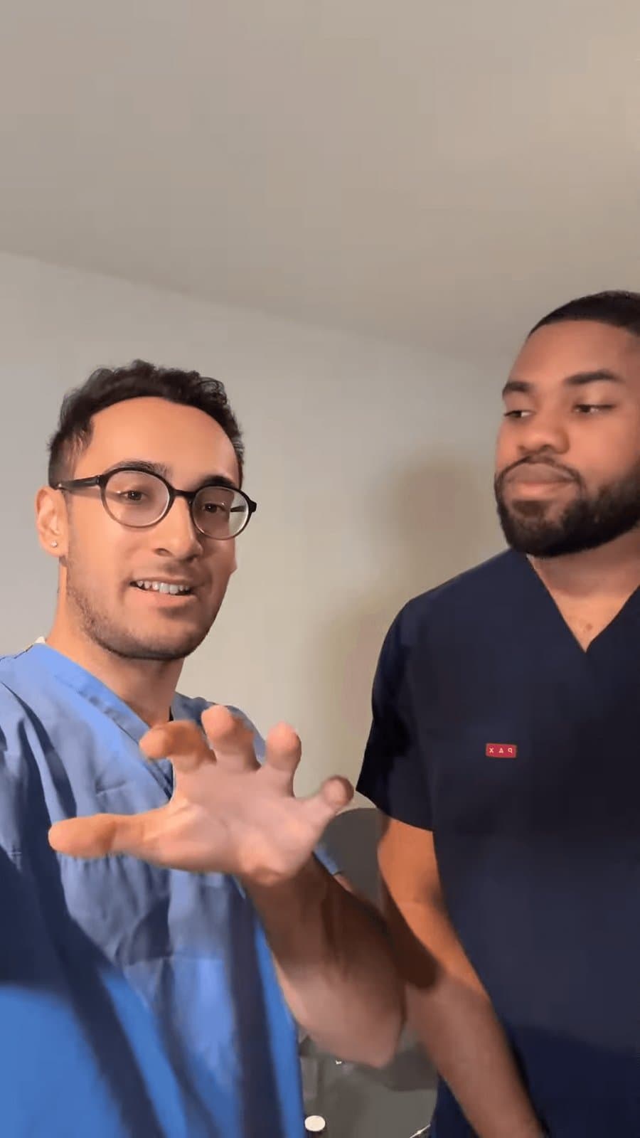 Dr Dev Gakhar filming with a colleague in scrubs