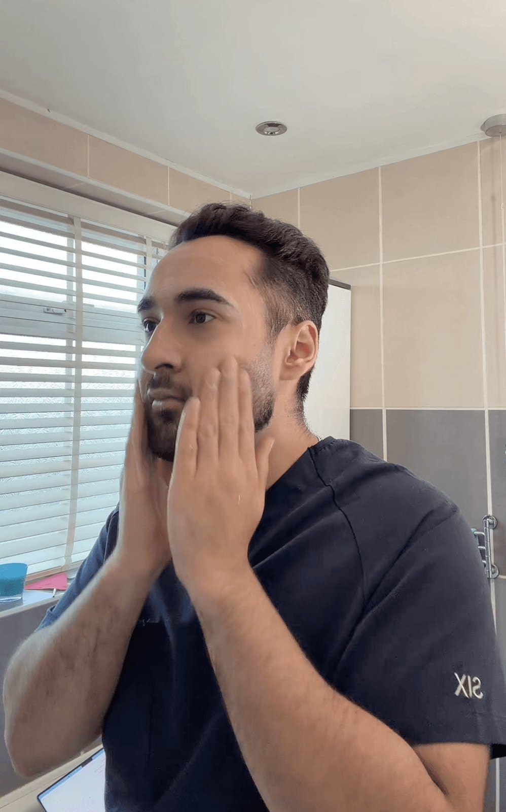Dr Dev Gakhar applying moisturiser in a skincare explainer