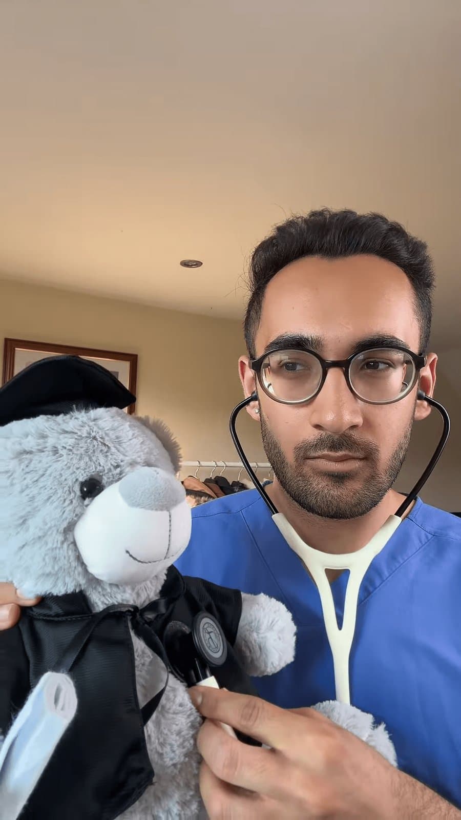Dr Dev Gakhar auscultating a teddy bear with a Littmann stethoscope