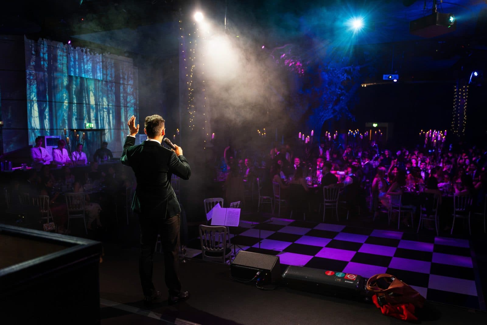 Dr Dev speaking on stage at the Imperial College London Halfway Ball